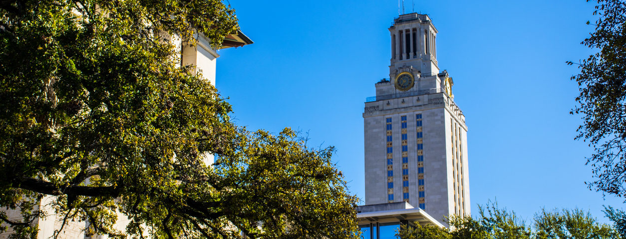 UT Tower Campus Courtyard Nice Morning Sunshine on the University of Texas at Austin with the UT Clock Tower in the background standing tall on a nice clear Sunny Blue Sky morning. Also the same tower that the UT Tower Mass Shooting took place.