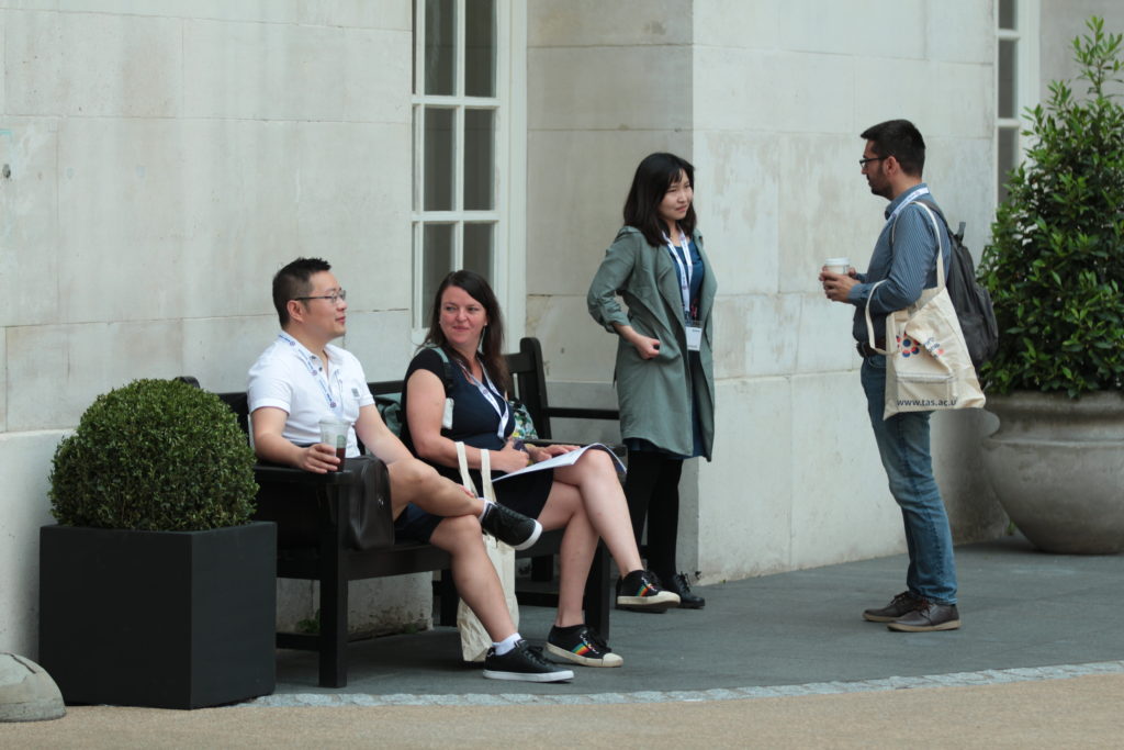 Delegates in conversation outside the building