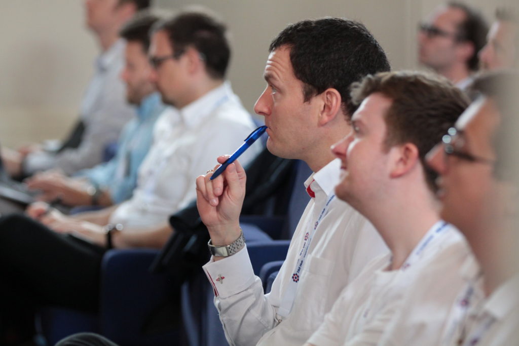 Ben Pritchard, Chief Technologist in the Autonomy Technology Centre, Thales, watches a talk in the Great Hall