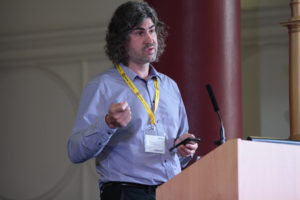 Professor Joel Fischer on stage giving a talk