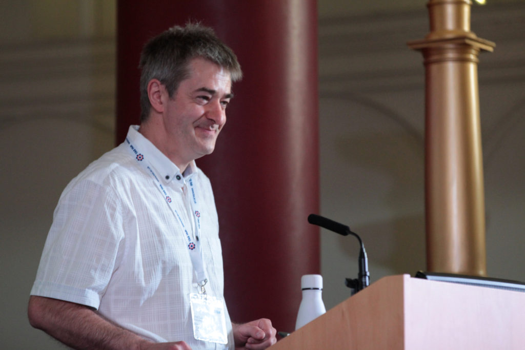 Professor Radu Calinescu gives a talk on stage