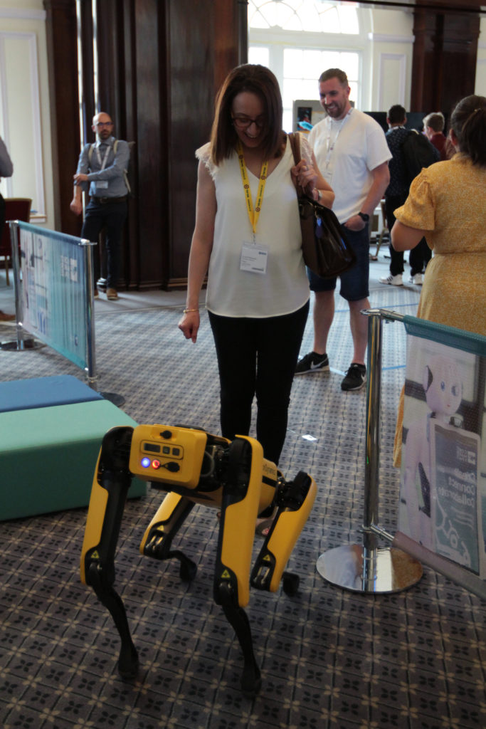 A dog-like robot interacts with a delegate