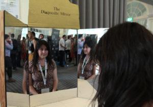 Rachel Jacobs sat in front of three mirrors