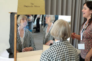 Professor Sharon Strover sits in front the diagnostic mirror , Rachel Jacobs is on the right