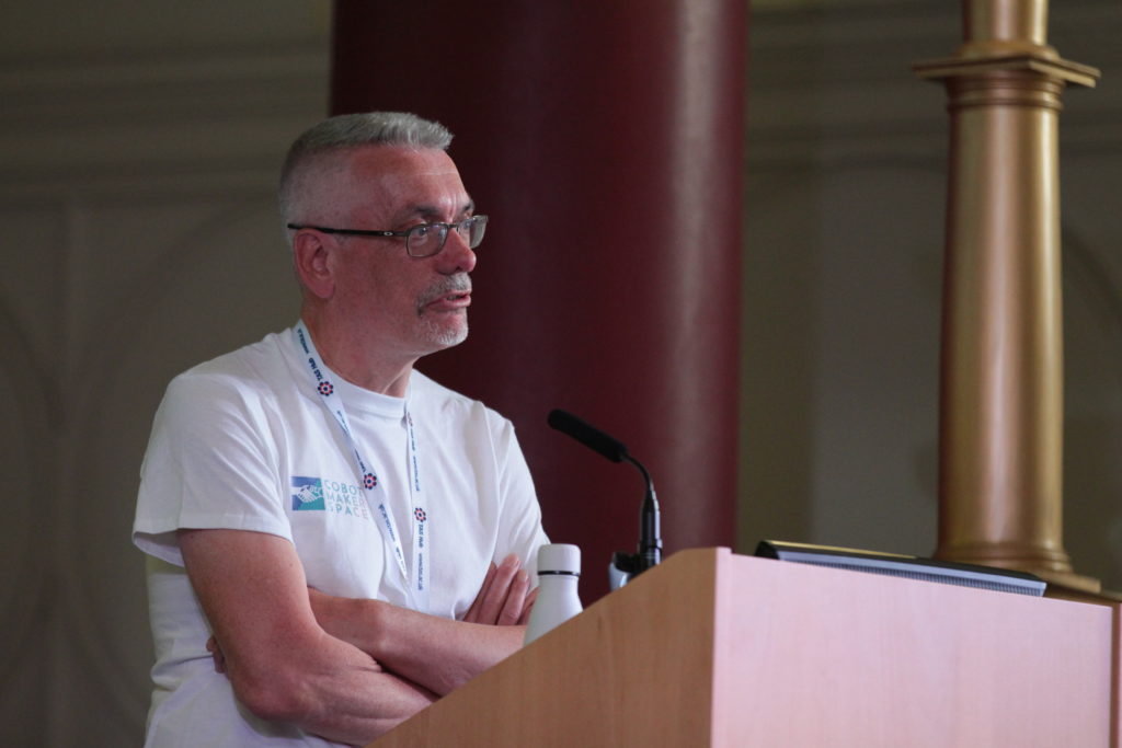 Professor Steve Benford stands at the podium