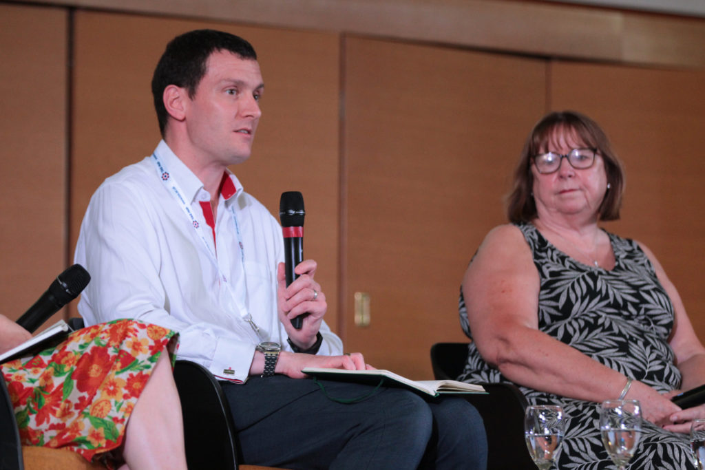 Ben Pritchard with a microphone, Dame Wendy Hall seated beside him