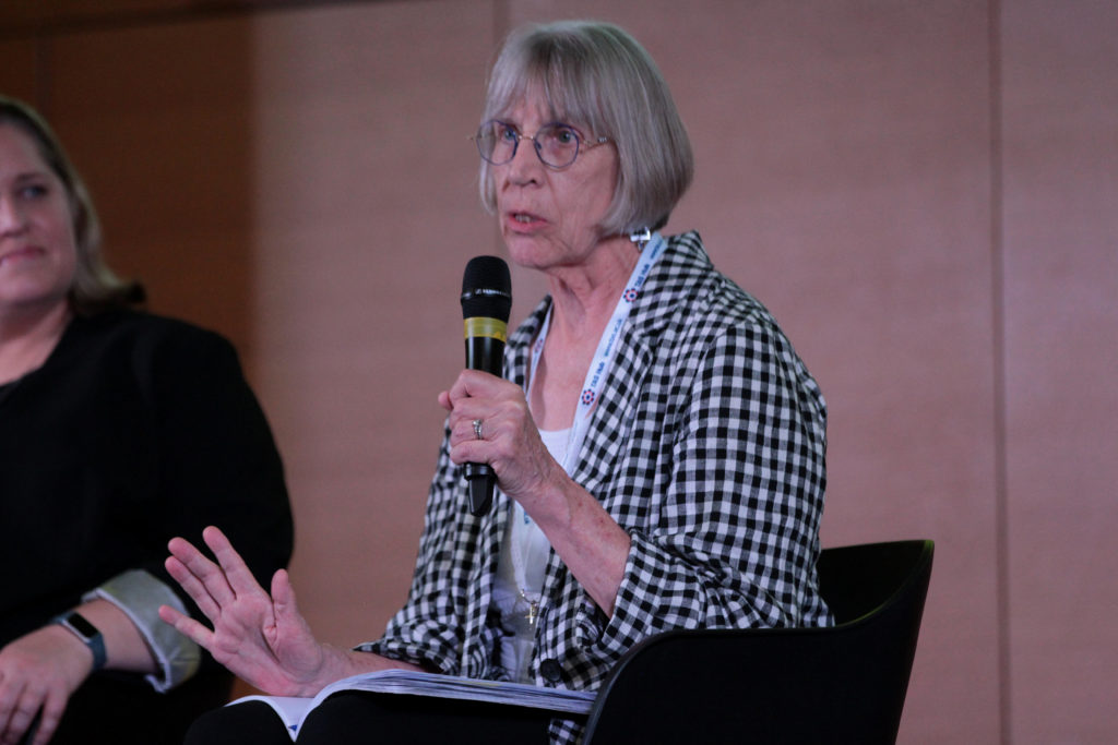 Professor Sharon Strover stands with a microphone