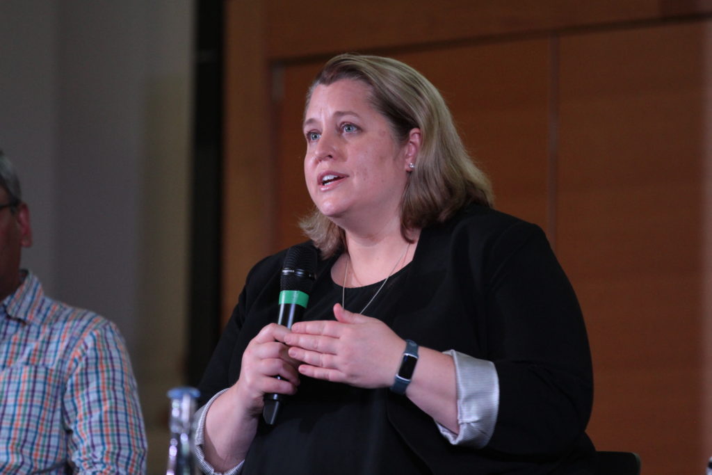 Cara LaPointe speaks into a microphone