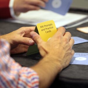 Hands holding RRI Prompts and Practice Cards