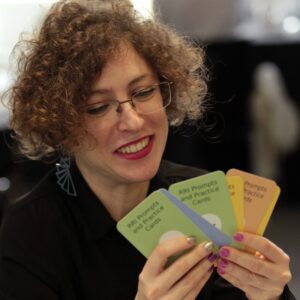 Female researcher holding RRI Prompts and Practice Cards
